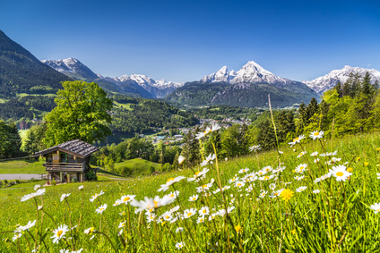 Idyllic landscape in the Alps with mountain lodge in spring